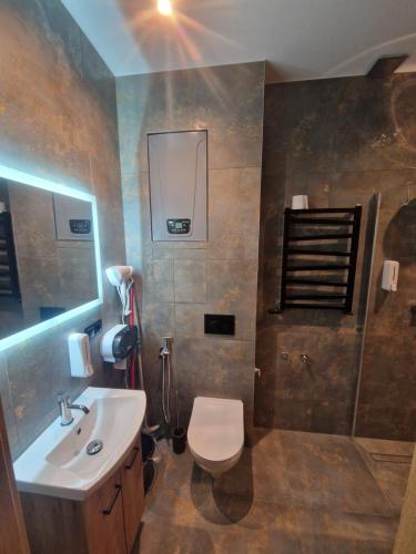 a bathroom with a toilet and a sink at Apartament Zacisze 2 in Przemyśl