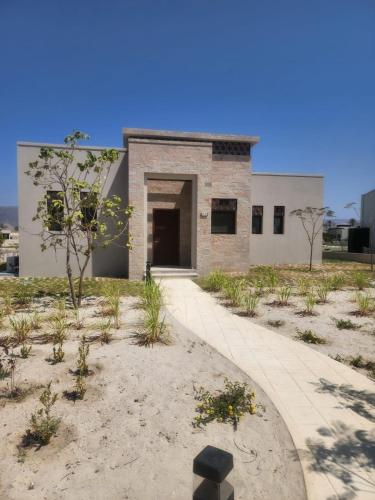 a brick building with an open door in the desert at Two bedroom Villa with Private Pool, Hawana Salalah in Wādī Khasbar
