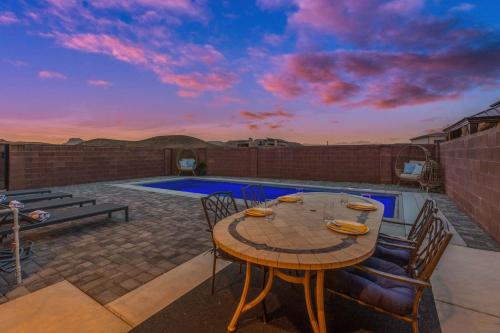 a patio with a table and chairs and a pool at Luxury Poolside Retreats Near Zion l Private Pools in Hurricane