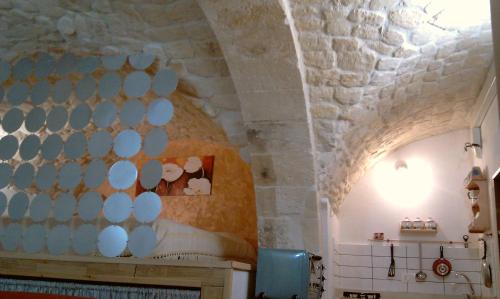 a bedroom with a bed in a stone wall at Dammuso Raffaello in Scicli