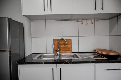 a kitchen with a sink and a stainless steel refrigerator at Reveuse in Pretoria