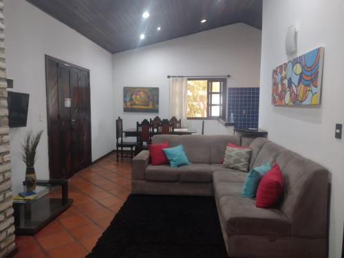 a living room with a couch and a table at Pousada Aquarela Pipa in Pipa