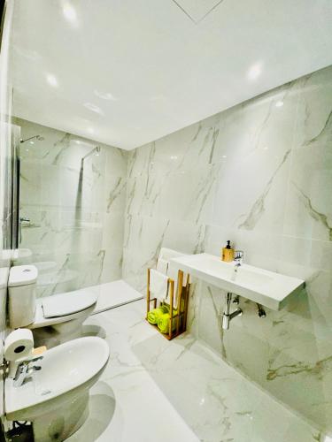 a white bathroom with a sink and a toilet at VALE MAR Guest in Ribeira Brava