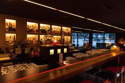 a bar with a lot of bottles on the wall at SeminarHotel am Ägerisee in Unterägeri