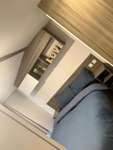 a bedroom with a bed and a wooden cabinet at Lyons Winkups holiday park ll22 9EL in Kinmel Bay