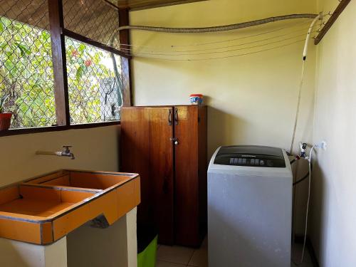 a bathroom with a sink and a trash can at Vista Drake Lodge in Drake Bay Airport