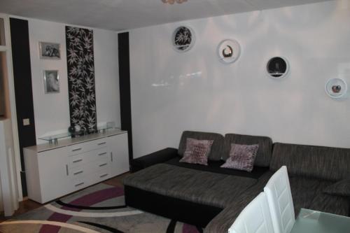 a living room with a couch and a dresser at BS Business Travelling Hannover City in Hannover