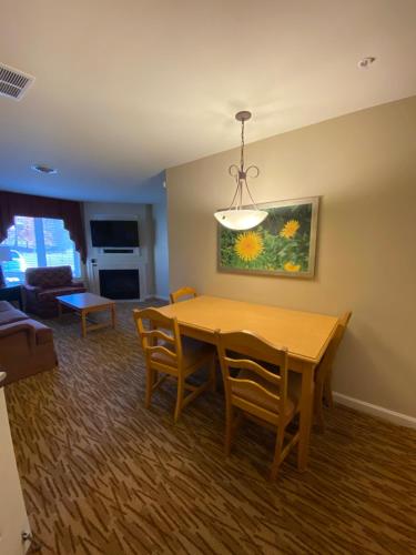 a living room with a dining room table and chairs at Vacation Village in the Berkshires in Hancock