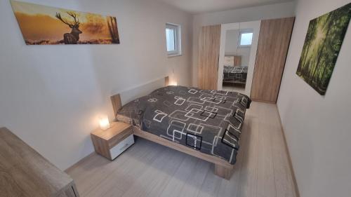a small bedroom with a bed and a night stand at Ferienwohnung Zum Pflanzgarten in Herresbach