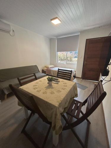 a room with a table and chairs and a couch at Casa Acuario in Mercedes