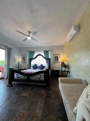 a bedroom with a bed and a ceiling fan at Hacienda del Lago Boutique Hotel in Ajijic