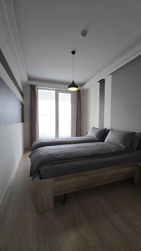 a bedroom with a large bed and a window at 33th Floor - SkyView Oasis - A in Skopje