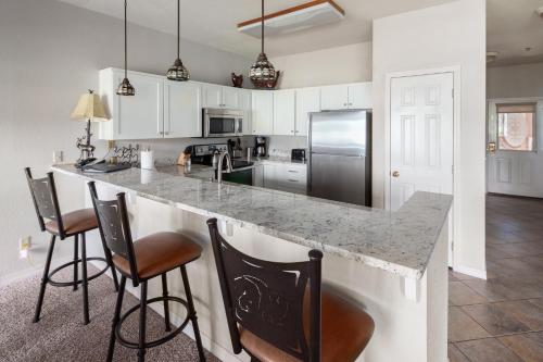 a kitchen with a large counter with bar stools at Lodge at Whitefish Lake in Whitefish