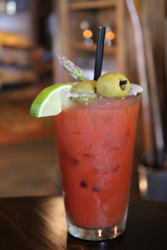a drink on a table with a lime and a straw at Lodge at Whitefish Lake in Whitefish