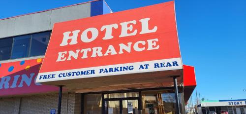 a sign for a hotel entrance in front of a building at The Lodge Inn in Edmonton