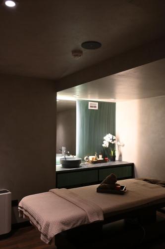 a bedroom with a bed and a sink in a bathroom at Luxury Premium Finese in Golem