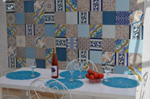 a table with glasses of wine and a bowl of fruit at Residence Le Terrazze in Sorrento