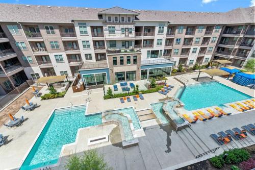 an aerial view of a pool at a hotel at Modern 1BR near TPC Golf in McKinney