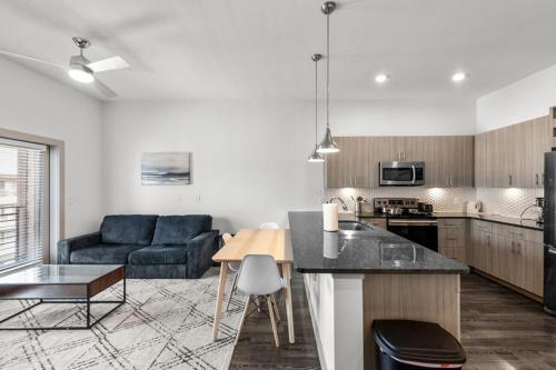 a kitchen and living room with a couch and a table at Modern 1BR near TPC Golf in McKinney