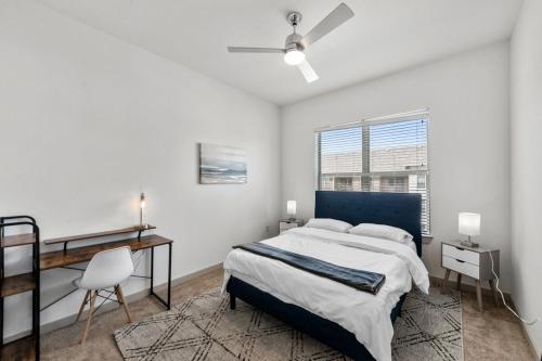 a bedroom with a bed and a desk and a window at Modern 1BR near TPC Golf in McKinney