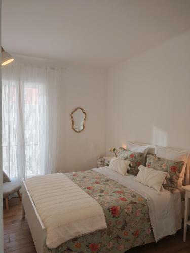 a white bedroom with a large bed in a room at appartement perpignan in Perpignan