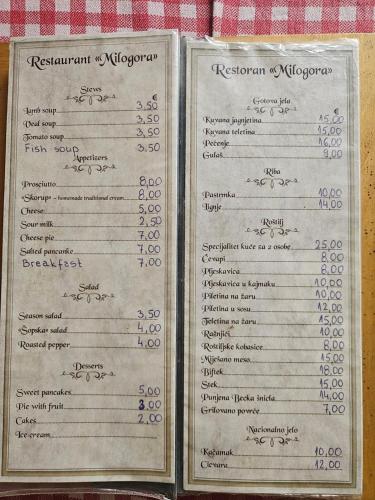 a menu for a restaurant on a table at Guest House Ethno Village Milogora in Pluzine