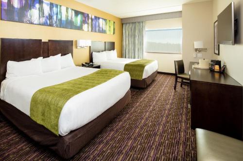 a hotel room with two beds and a desk at Harrah's Cherokee Valley River, A Caesars Destination in Murphy