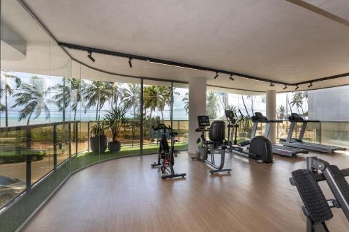 an indoor gym with treadmills and exercise equipment in a building at Setai Yacht by DayByDay in João Pessoa