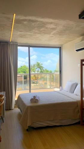 a bedroom with a large bed with a large window at Setai Yacht by DayByDay in João Pessoa