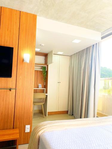 a hotel room with a bed and a television at Setai Yacht by DayByDay in João Pessoa