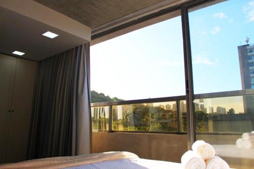 a bedroom with a bed and a large window at Setai Yacht by DayByDay in João Pessoa