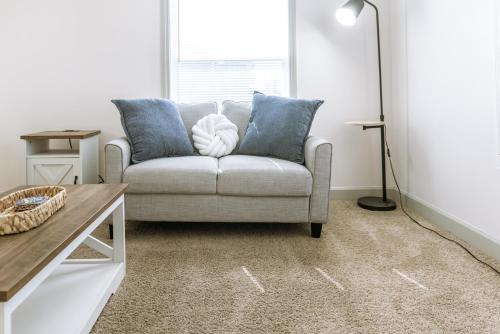 a living room with a couch and a window at Coastal Hubert 3bed Home-Covered Patio, Pet-friendly! in Hubert