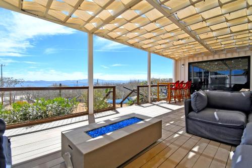 a living room with a couch and a table at 20-30 Knots- 5br4ba Game Night Villa Hot Tub in El Sargento