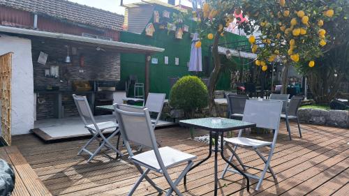 a patio with a table and chairs on a deck at Ruby Charm Houses in Porto