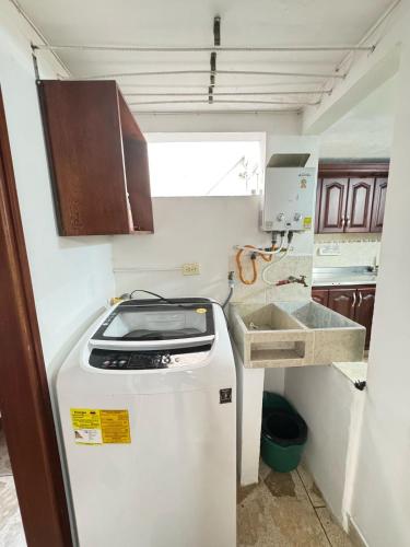 a small kitchen with a sink and a refrigerator at Apartamento Edificio Parques Del Trianon in Envigado