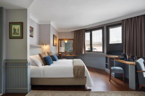 a hotel room with a bed and a desk at Armada Istanbul Old City Hotel in Istanbul