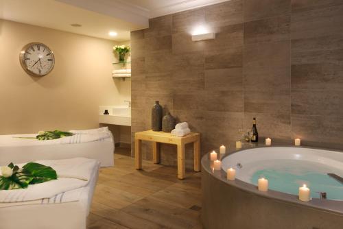 a bathroom with a tub with candles in it at U Magic Palace in Eilat