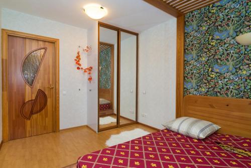 エカテリンブルクにあるСелимВсех на Валекаのベッドルーム1室(ベッド1台付)が備わります。壁には絵画が飾られています。
