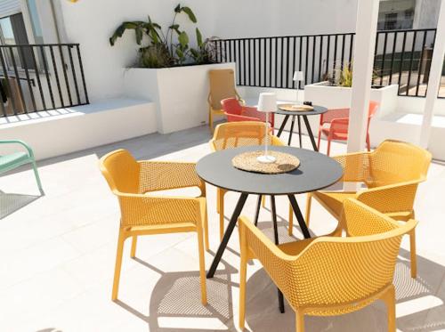 a group of chairs and tables on a patio at Harmonies BnB in Bari