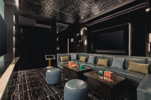 a living room with a couch and a flat screen tv at Holiday Inn Wuhan Tianhe Airport by IHG in Wuhan