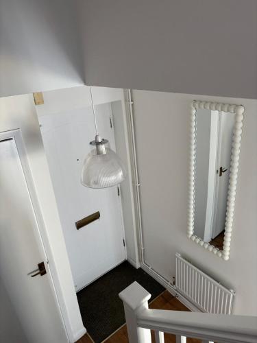 a hallway with a mirror and a white door at Home in Canterbury only 2 min walk to Cathedral in Canterbury