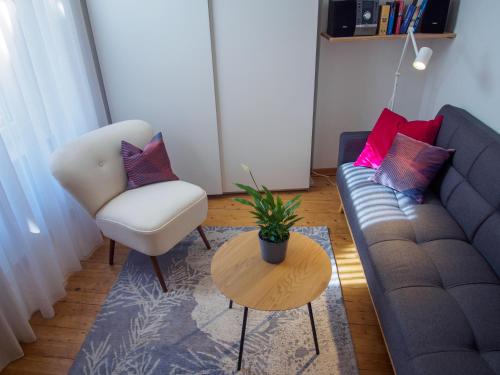 a living room with a couch and a chair at Ferienwohnung in Ehrenbreitstein in Koblenz