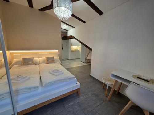 a small bedroom with a bed and a table at Hotel Surselva in Chur