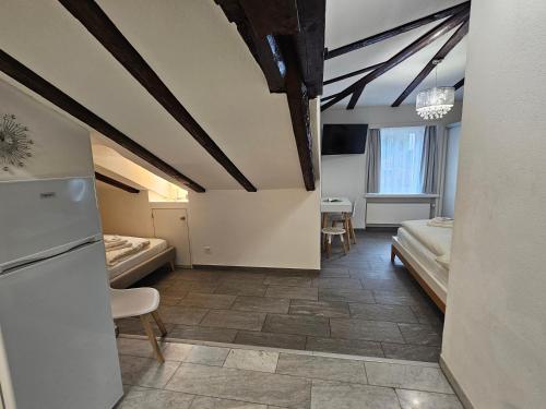 a room with two beds and a room with a kitchen at Hotel Surselva in Chur