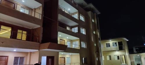 a tall apartment building at night with its lights on at Spacious Black Themed Apartment Victoria Island in Lagos