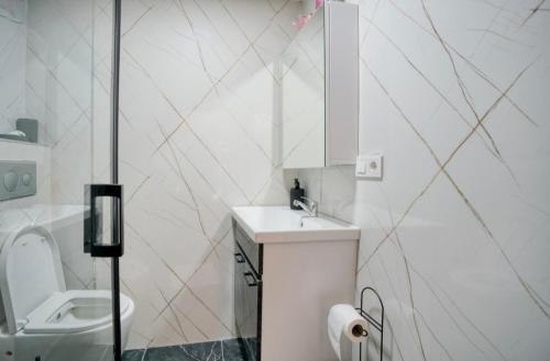 a white bathroom with a sink and a toilet at Cendere Old City Hotel in Istanbul