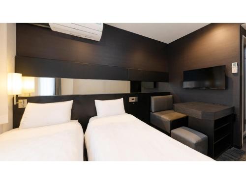 a hotel room with two beds and a tv at The OneFive Osaka Namba Dotonbori - Vacation STAY 51549v in Osaka