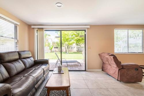 a living room with a couch and a chair at paradise vacation luxury home in Palm Bay