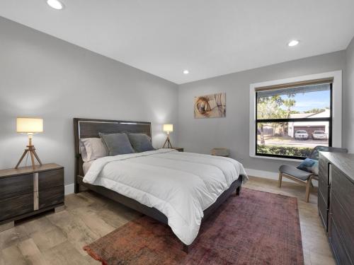 a bedroom with a large bed and a window at Tropical Dream House in Plantation 3 Bedroom Home with Pool in Plantation