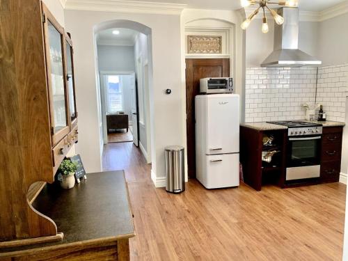a kitchen with a white refrigerator and a stove at The 1900 House 1 Block From DT in Prescott